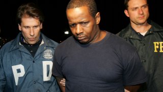 FILE - In this Thursday, May 21, 2009 picture, James Cromitie, center, is led by police officers from a federal building in New York after being arrested on charges related to a bombing plot in the Bronx. Cromitie, convicted in a post-9/11 terrorism sting was ordered freed from prison, Friday, Jan. 19, 2024, by a judge who criticized the FBI for relying on an "unsavory” confidential informant who sought the “poorest and weakest” men in a fictitious plot to blow up New York synagogues and shoot down National Guard planes. (AP Photo/Robert Mecea, File)