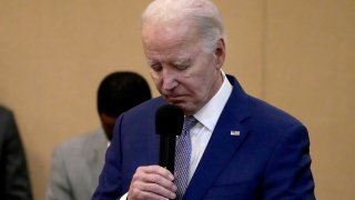 President Biden bows his head in a moment of silence for the three American troops killed Sunday