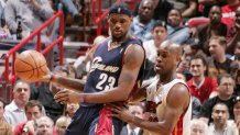 MIAMI - FEBRUARY 2:  LeBron James #23 of the Cleveland Cavaliers dribbles against Gary Payton #20 of the Miami Heat at the American Airlines Arena February 2, 2006 in Miami, Florida. The Heat won 101-73. NOTE TO USER: User expressly acknowledges and agrees that, by downloading and or using this photograph, user is consenting to the terms and conditions of the Getty Images License Agreement. Mandatory Copyright Notice: Copyright 2006 NBAE (Photo by Nathaniel S. Butler/NBAE via Getty Images)