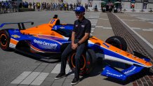 FILE - Kyle Larson sits on the car that he will drive in the IndyCar Indianapolis 500 after is was unveiled at Indianapolis Motor Speedway in Indianapolis, Sunday, Aug. 13, 2023. Larson will attempt to drive both the Indianapolis 500 and the Charlotte NASCAR Cup Series auto races on the same day next year. Larson nearly lost control of his Arrow McLaren ride during a four-plus-hour test at Phoenix Raceway on Monday, Feb. 5, 2024, but the NASCAR star and 2021 Cup Series champion managed to save the open-wheel car from hitting the wall at 180 mph.(AP Photo/Michael Conroy, File)