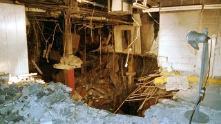 FILE – The crater in an underground parking garage from the World Trade Center explosion is shown in this Feb. 27, 1993 photo. New York City is marking the anniversary of the 1993 bombing that blew apart a van parked in an underground garage, killing six people and injured more than 1,000. The Port Authority of New York and New Jersey is holding a memorial Mass on Monday, Feb. 26, 2024 at St. Peter’s Church in Manhattan. (AP Photo/Richard Drew, file)