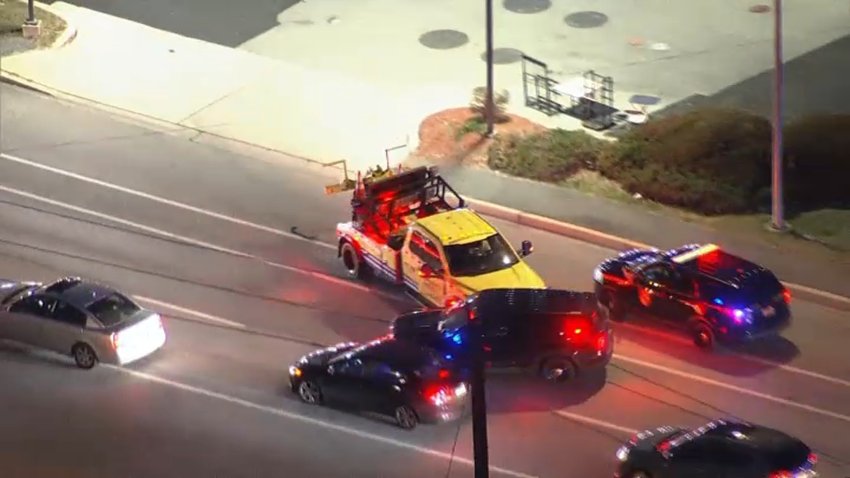 A stolen roadside assistance truck rams a police car amid a rush hour chase.