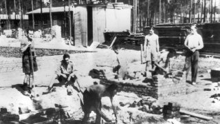 Captured RAF officers at Stalag Luft 3 lay the foundations for a new hut, 1944