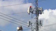 A man climbs a cell tower in Miami on April 3, 2024.