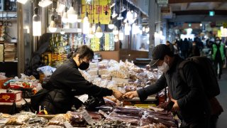 A customer pays for his purchase at a dried food stall in Seoul, South Korea, on Thursday, March 3, 2022. Photographer: SeongJoon Cho/Bloomberg via Getty Images