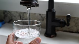 In this photo illustration, water flows from a tap on July 06, 2023 in San Anselmo, California. According to a study by the US Geological Survey, nearly half of the tap water in the United States is contaminated with “forever chemicals” that are considered dangerous to human health. 