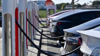 Drivers charge their Teslas in Fountain Valley, CA, on Wednesday, March 20, 2024.