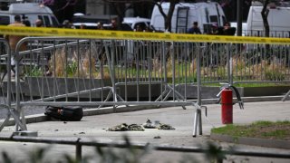 Fire extinguishers (R) are left at the park across from Manhattan Criminal Court in New York City after a man reportedly set himself on fire during the trial of former U.S. President Donald Trump, in New York City on April 19, 2024.