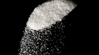 Granulated sugar is poured using a spoon. (AP Photo/Matt Rourke, File)