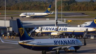 Passengers board an aircraft, operated by Ryanair Holdings Plc, on the tarmac at London Stansted Airport, operated by Manchester Airport Plc, in Stansted, UK, on Monday, Nov. 6, 2023.