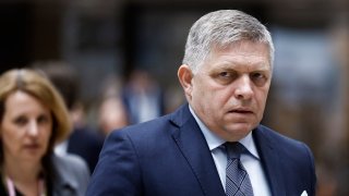 Slovakia’s Prime Minister Robert Fico walks during the European Council summit at the EU headquarters in Brussels, on April 18, 2024. 