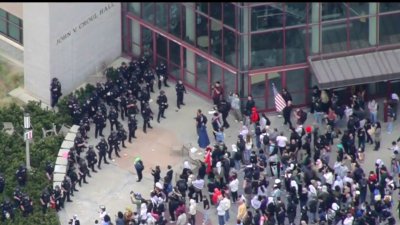 Police moving in on building with protesters at UCI