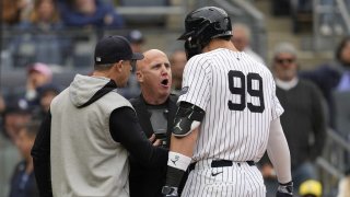 New York Yankees manager Aaron Boone, left, and Aaron Judge (99) argue with home plate umpire Ryan Blakney, center, after Blakney ejected Judge from the game in the seventh inning of a baseball game against the Detroit Tigers, Saturday, May 4, 2024, in New York. (AP Photo/Mary Altaffer)