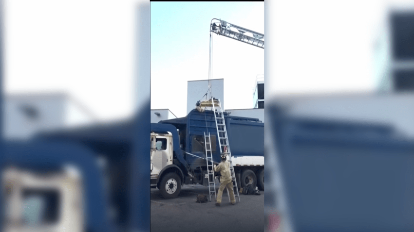 Firefighters rescue man from inside a dumpster truck in Colorado Springs, Colorado.