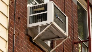 NEW YORK, NY – JULY 28: An air conditioner is seen in a residential windows on July 28, 2020 in New York City.  With temperatures once again reaching above 90 degrees, most city dwellers rely on these units to cool their homes. The current heat wave comes only days after another stretch of warm air pushed temperatures to record levels, prompting safety warnings from the city’s Office of Emergency Operations.