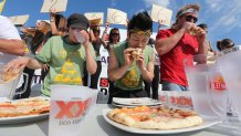 BARRIE, ON - SEPTEMBER 16: Flanked by Stephanie Torres and Pete Czerwinski, Takeru "Kobi" Kobayashi defends his pizza eating title, the super eater ate 40 slices of a simple cheese and sauce pizza in 12 minutes at Pie Wood Pired Pizza Joint in Barrie.        (Steve Russell/Toronto Star via Getty Images)