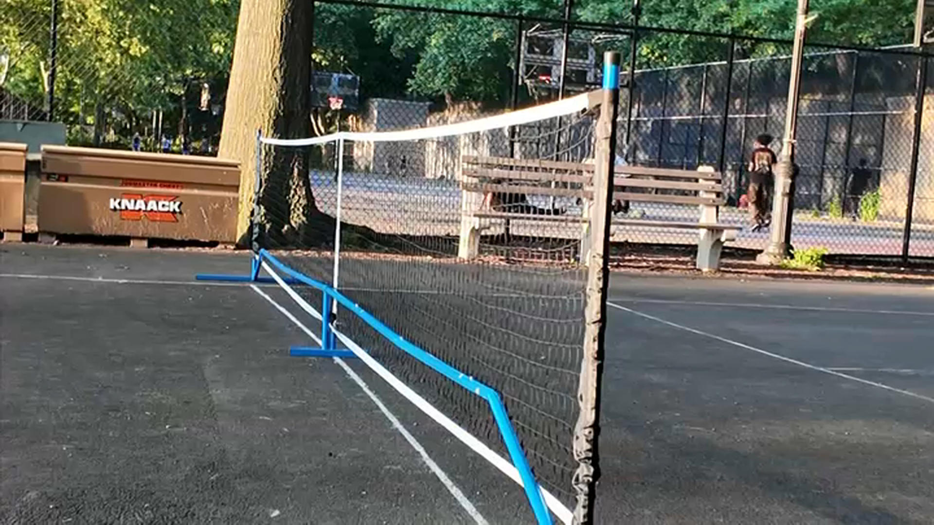 A portable net is set up at a pickleball court.