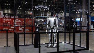 A mockup of Tesla Inc.’s planned humanoid robot Optimus on display during the Seoul Mobility Show in Goyang, South Korea, on Thursday, March 30, 2023. The motor show will continue through April 9. Photographer: SeongJoon Cho/Bloomberg via Getty Images