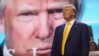 Former US President and 2024 Republican presidential candidate Donald Trump raises his fist as he walks off stage after participating in a town hall event at Dream City Church in Phoenix, Arizona, on June 6, 2024. 