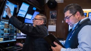 Traders work on the floor of the New York Stock Exchange.