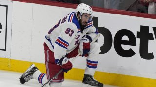 New York Rangers center Mika Zibanejad (93) kneels on the ice after his team lost Game 6 to the Florida Panthers in the Eastern Conference finals of the NHL hockey Stanley Cup playoffs Saturday, June 1, 2024, in Sunrise, Fla. (AP Photo/Lynne Sladky)