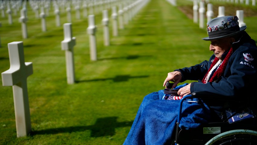 World War II and D-Day veteran Jake Larson visits the grave of a soldier from his unit at the Normandy American Cemetery in Colleville-sur-Mer, France, Tuesday, June 4, 2024. World War II veterans from across the United States as well as Britain and Canada are in Normandy this week to mark 80 years since the D-Day landings that helped lead to Hitler's defeat.