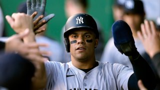 New York Yankees’ Juan Soto celebrates in the dugout after scoring on a single by Alex Verdugo during the first inning of a baseball game against the Kansas City Royals Monday, June 10, 2024, in Kansas City, Mo. (AP Photo/Charlie Riedel)