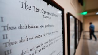 FILE - A copy of the Ten Commandments is posted along with other historical documents in a hallway of the Georgia Capitol, Thursday, June 20, 2024, in Atlanta. Civil liberties groups filed a lawsuit Monday, June 24, challenging Louisiana’s new law that requires the Ten Commandments to be displayed in every public school classroom.