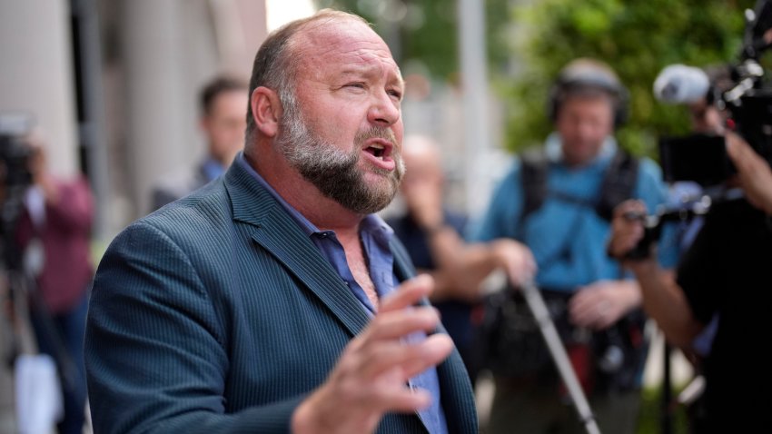 FILE – Right-wing conspiracy theorist Alex Jones speaks to the media after arriving at the federal courthouse for a hearing in front of a bankruptcy judge, Friday, June 14, 2024, in Houston. A federal bankruptcy judge Thursday, June 27, stopped an effort by the parents of a boy killed in the Sandy Hook Elementary School shooting to collect on some of the $50 million owed to them by Jones and his company for his claims that the massacre was a hoax.