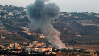 A smoke plume billows during Israeli bombardment