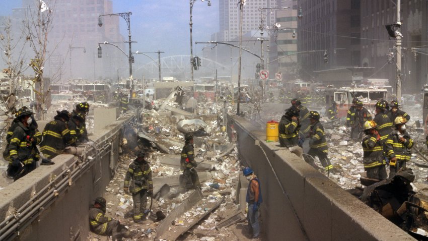 Colour photograph of New York Firefighters amid the rubble of the World Trade Centre following the 9/11 attacks. Dated 2001.