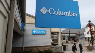 A Columbia Sportswear Company sign hangs in front of their store at the Woodbury Common Premium Outlets shopping mall on November 17, 2019 in Central Valley, New York.