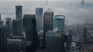 LONDON – Nov. 5, 2020: Fog shrouds the Canary Wharf business district including global financial institutions Citigroup Inc., State Street Corp., Barclays Plc, HSBC Holdings Plc and the commercial office block No. 1 Canada Square.