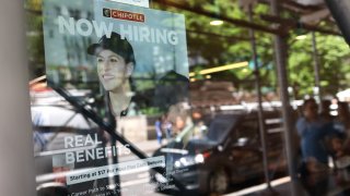 A “Now Hiring” sign is seen at a FedEx location on Broadway on June 07, 2024 in New York City. 