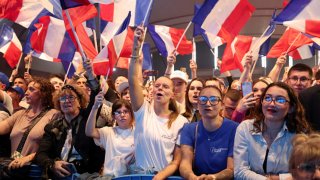 Supporters wave the national flag of France during a campaign meeting of France’s far-right Rassemblement National (RN) party’s President and lead European Parliament election candidate Jordan Bardella and President of the French far-right Rassemblement National (RN) parliamentary group Marine Le Pen, ahead of the upcoming European Union (EU) parliamentary elections, in Henin-Beaumont, northern France, on May 24, 2024. 