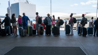 People move through a crowded JFK International Airport days before the 4th of July holiday on July 02, 2024 in New York City. 