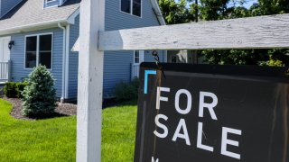 Patchogue, N.Y.: A For Sale sign hangs in front of a house in Patchogue, New York, on June 1, 2024. 