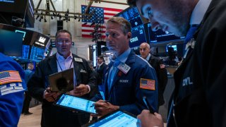 Traders work on the floor of the New York Stock Exchange on July 11, 2024.