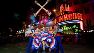 Dancers perform in front of the Moulin Rouge cabaret during the inauguration of the theatre’s windmill, in Paris, Friday, July 5, 2024.