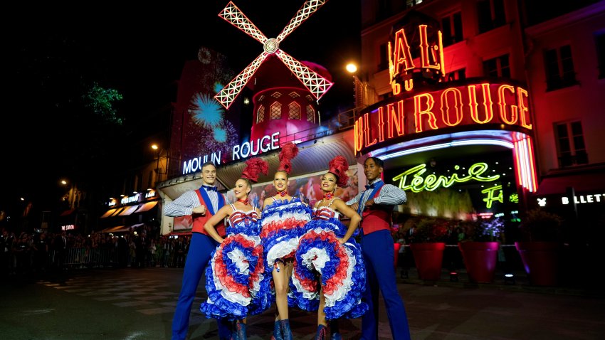 Dancers perform in front of the Moulin Rouge cabaret during the inauguration of the theatre’s windmill, in Paris, Friday, July 5, 2024.