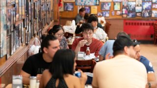 FILE - Customers have lunch at Katz's Delicatessen on Sept. 30, 2020 in New York. In a recent column, New York Times restaurant critic Pete Wells announced he's leaving the beat because the constant eating has led to obesity and other health problems. (AP Photo/Mary Altaffer, File)