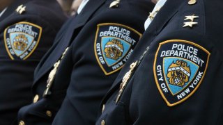 FILE – Members of the New York City Police Department listen to a news conference, Jan. 4, 2017, in New York. The head of an oversight board that investigates allegations of misconduct by NYC police officers has announced her resignation Monday, July 22, 2024, ending a tenure in which she had publicly criticized the NYPD’s handling of a major disciplinary case.