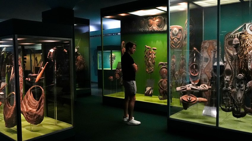 A person looks at a display in the Margaret Mead Hall of Pacific Peoples in the American Museum of Natural History in New York, Thursday, July 18, 2024. (AP Photo/Pamela Smith)