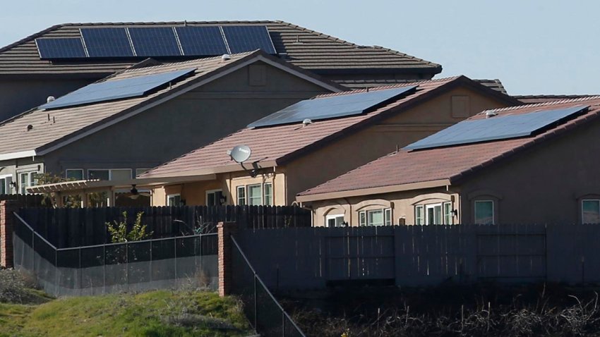 FILE - Solar panels on rooftops of a housing development in Folsom, Calif., on Feb. 12, 2020.