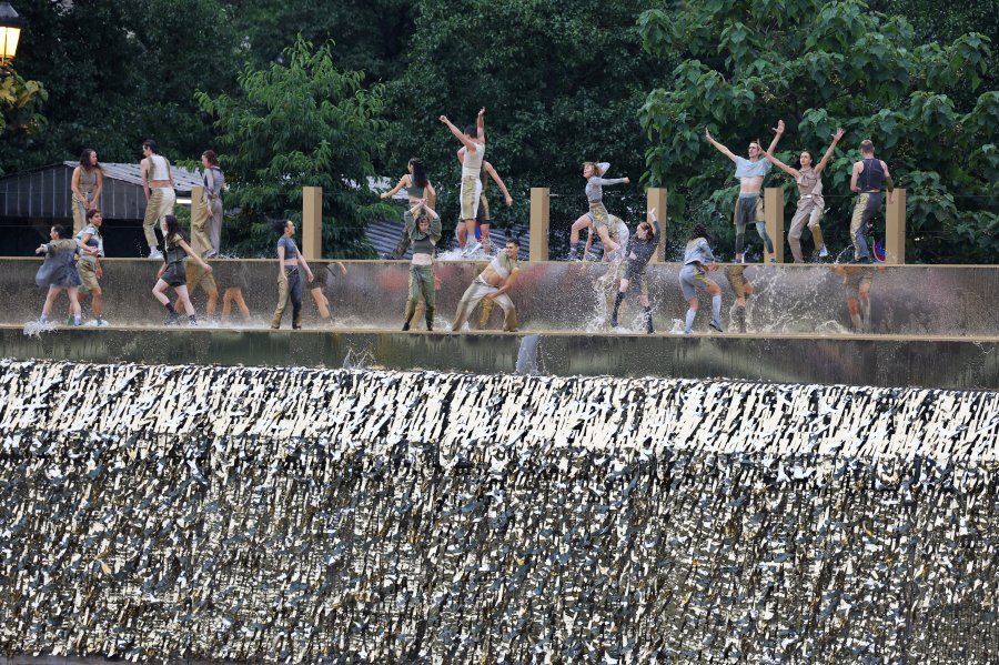 Dancers perform on the banks of the river Seine