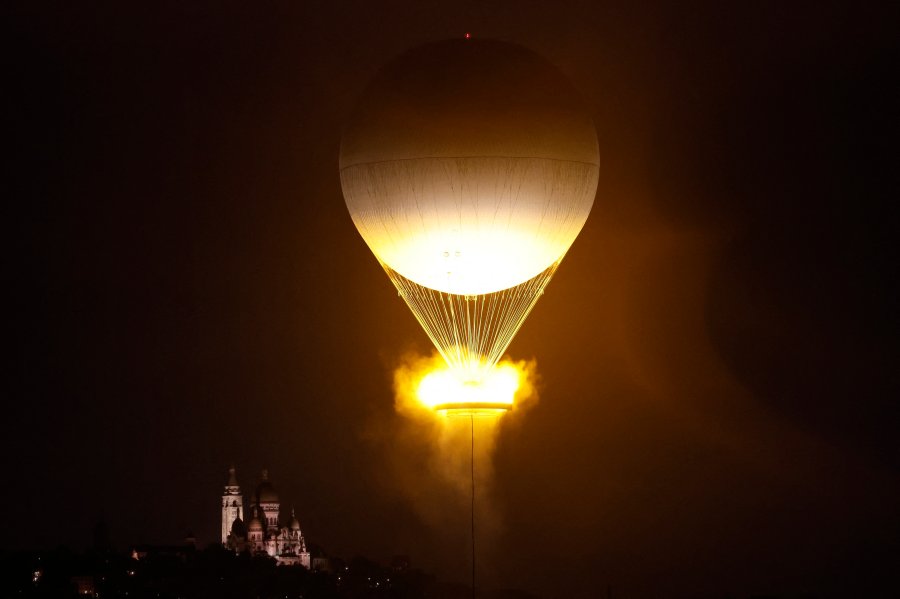 A general view shows a balloon holding the Olympic cauldron