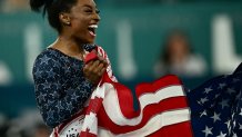 US' Simone Biles celebrates after team USA won the artistic gymnastics women's team final during the Paris 2024 Olympic Games at the Bercy Arena in Paris, on July 30, 2024. (Photo by Loic VENANCE / AFP) (Photo by LOIC VENANCE/AFP via Getty Images)