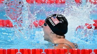 US’ Katie Ledecky celebrates after winning the final of the women’s 1500m freestyle swimming event during the Paris 2024 Olympic Games at the Paris La Defense Arena in Nanterre, west of Paris, on July 31, 2024. (Photo by Manan VATSYAYANA / AFP) (Photo by MANAN VATSYAYANA/AFP via Getty Images)