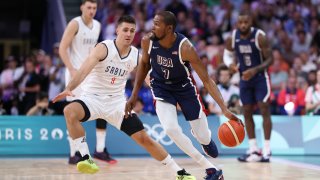 Kevin Durant of Team USA drives to the basket against Vanja Marinkovic of Team Serbia during the first half of the Men's Group Phase - Group C game