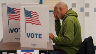 A voter fills out a ballot at a polling station on Election Day in Falls Church, Virginia, U.S., November 7, 2023. 